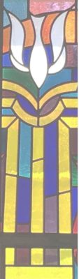 The symbol of the PC USA cross in stained glass. It appears as a stylized robe and descending dove.